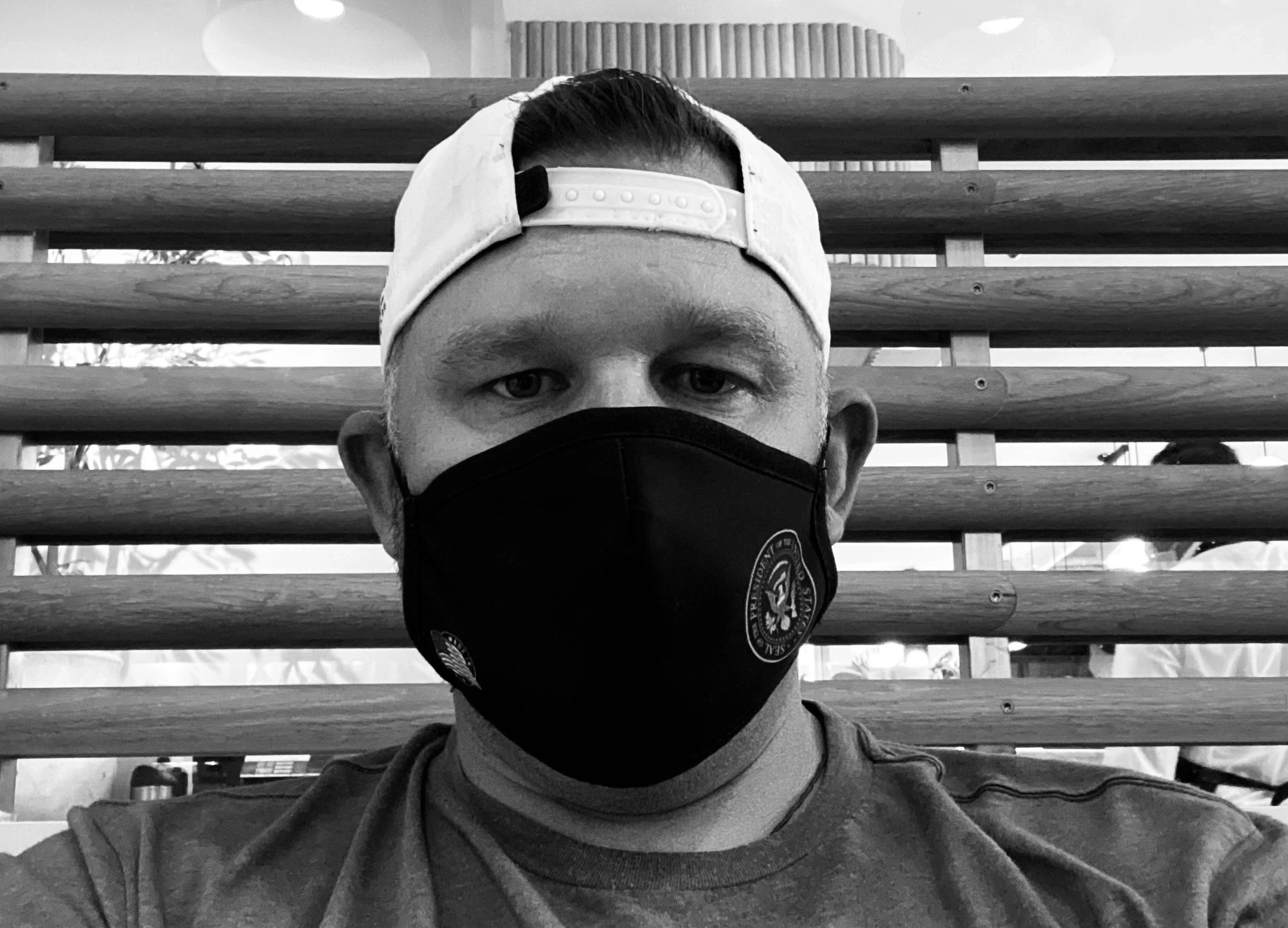 Michael wearing a mask and a backward baseball cap