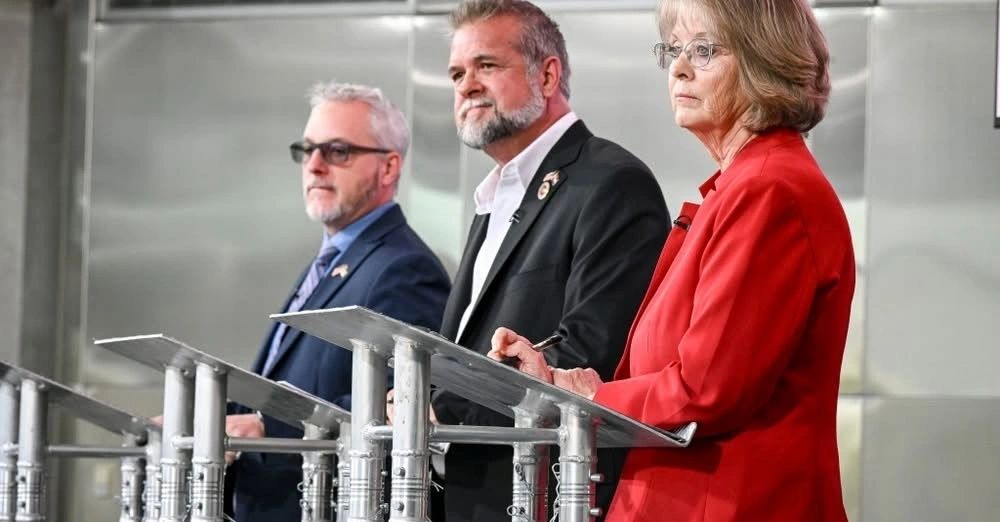 Three speakers at lecterns during a debate